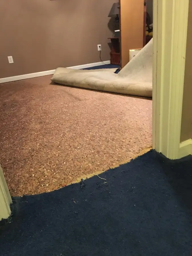 Carpet pad removal revealing water damage during Water Mitigation Services in Saddlebrooke